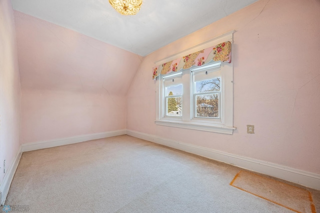 bonus room with carpet floors and vaulted ceiling