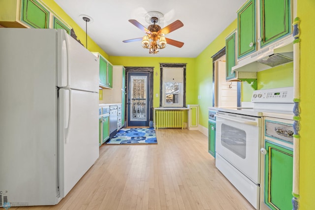 kitchen featuring white appliances, radiator, light countertops, under cabinet range hood, and pendant lighting