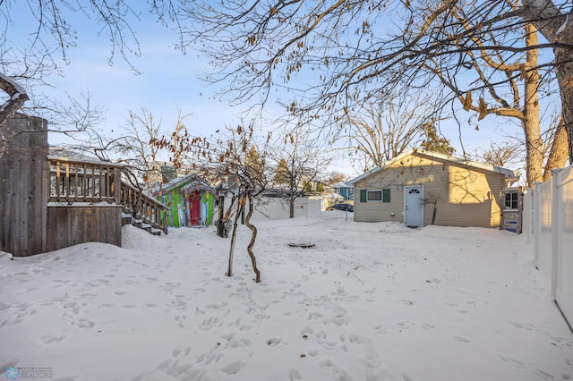 yard covered in snow with a garage