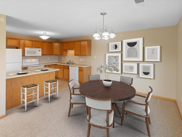 carpeted dining area featuring sink and a chandelier