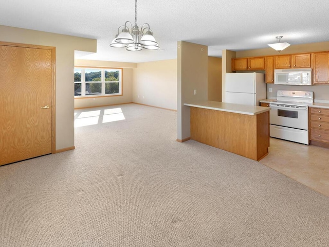 kitchen featuring a notable chandelier, white appliances, decorative light fixtures, a kitchen island, and light colored carpet