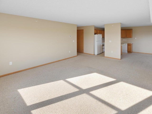 unfurnished living room with light colored carpet