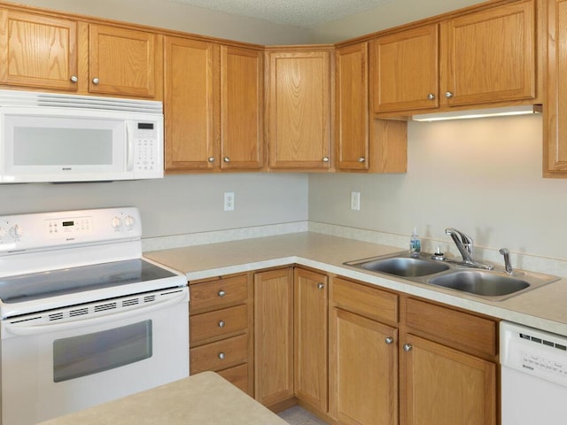 kitchen with sink and white appliances