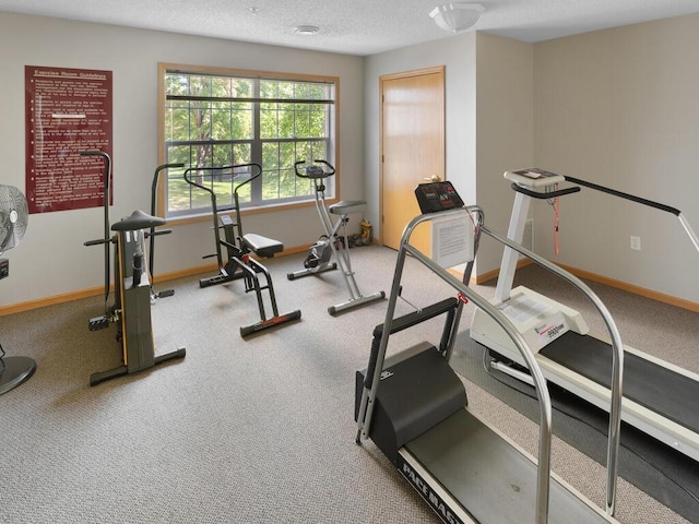 workout room featuring a textured ceiling