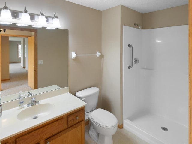 bathroom with vanity, toilet, and walk in shower