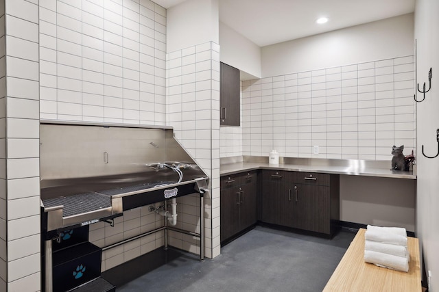 kitchen featuring dark brown cabinetry and stainless steel counters