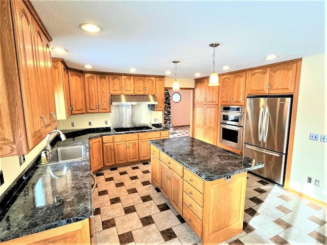 kitchen with sink, a center island, hanging light fixtures, dark stone counters, and appliances with stainless steel finishes