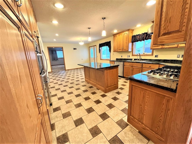 kitchen featuring a kitchen island, recessed lighting, appliances with stainless steel finishes, and a sink