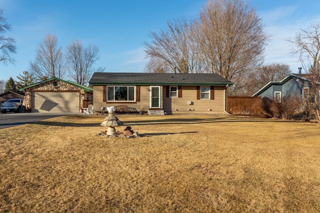 ranch-style home featuring a garage, driveway, and a front yard