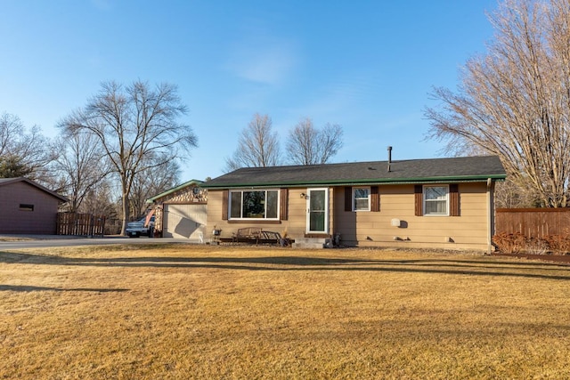 ranch-style home with a garage, fence, and a front yard