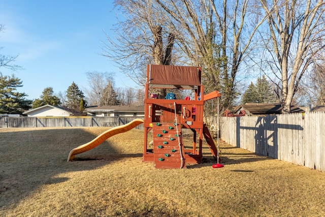 view of play area with a fenced backyard and a yard