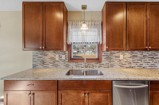 kitchen with stainless steel dishwasher, backsplash, a sink, and light stone counters