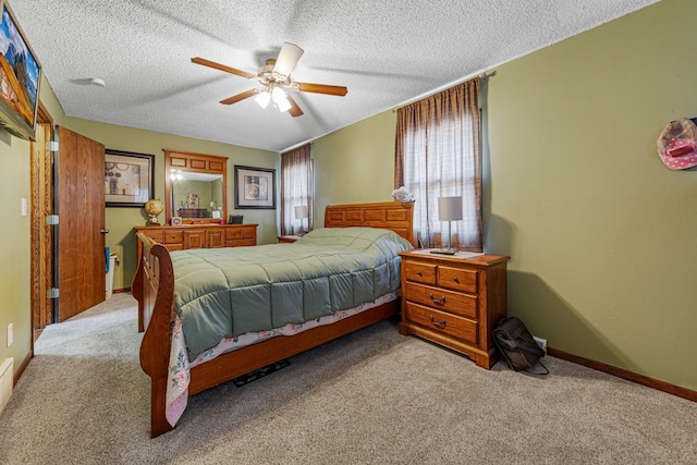 bedroom with a textured ceiling, ceiling fan, carpet flooring, and baseboards