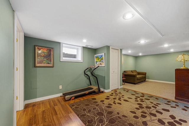 workout area with recessed lighting, visible vents, baseboards, and wood finished floors