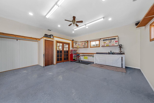 garage featuring french doors, ceiling fan, and baseboards