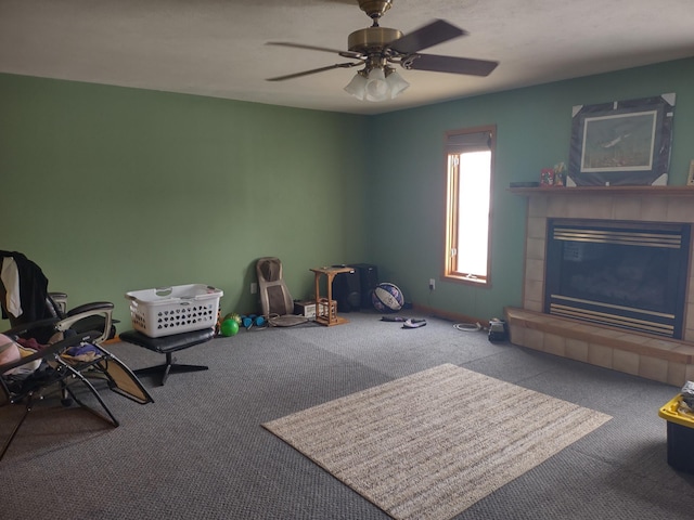 miscellaneous room featuring ceiling fan, carpet, and a fireplace