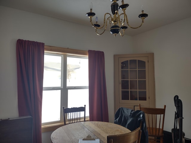 dining area featuring a wealth of natural light and a chandelier