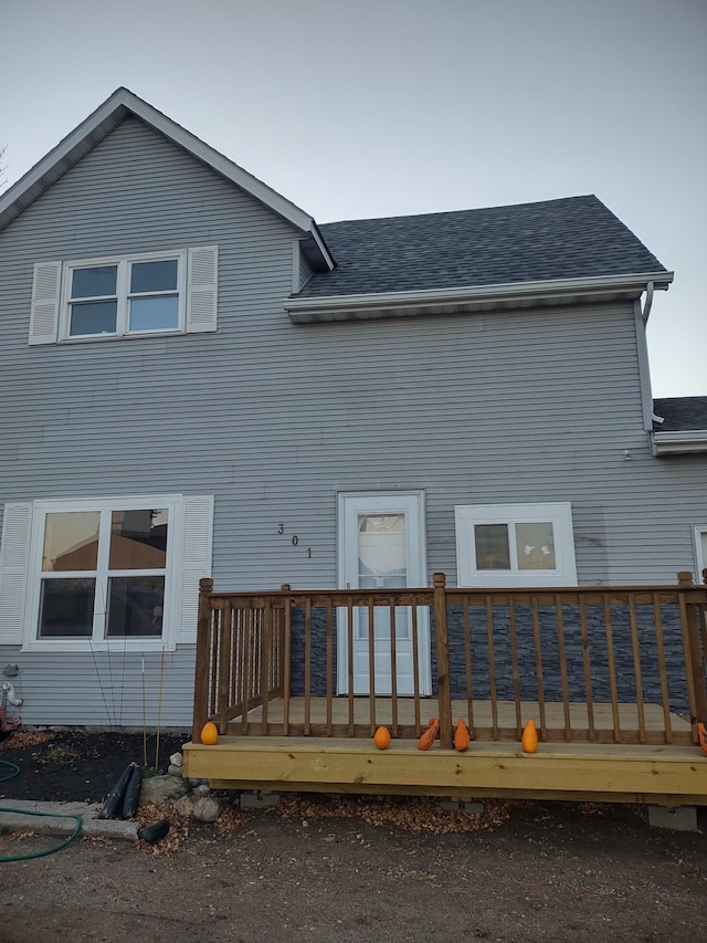 back of property with a wooden deck