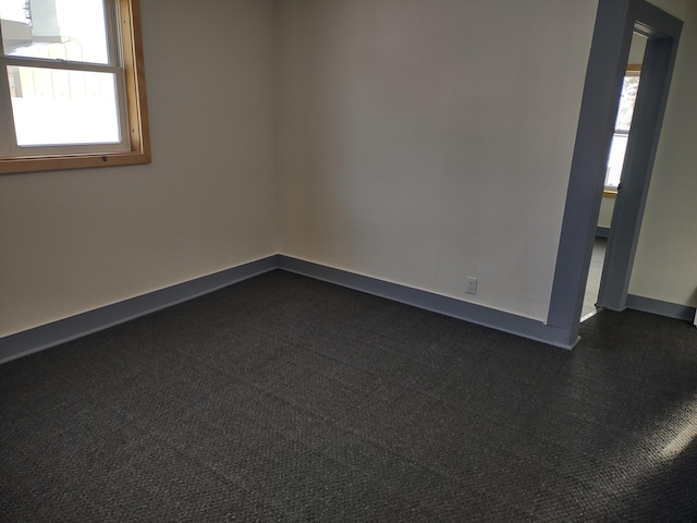 empty room with baseboards and a wealth of natural light