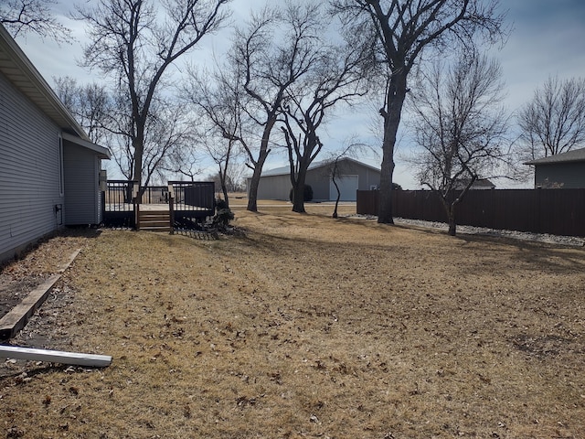 view of yard with a wooden deck and fence