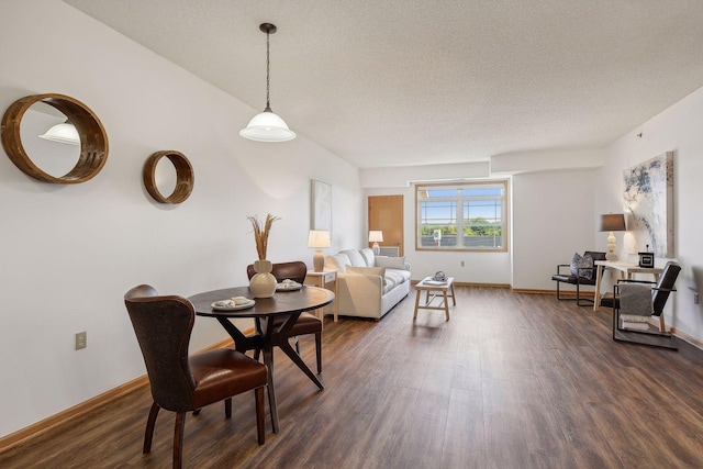 living room featuring dark hardwood / wood-style floors and a textured ceiling