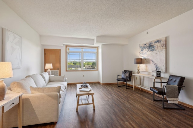 living room featuring a textured ceiling and dark hardwood / wood-style floors