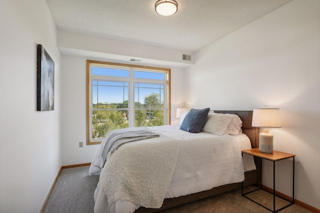 bedroom with carpet flooring and a textured ceiling