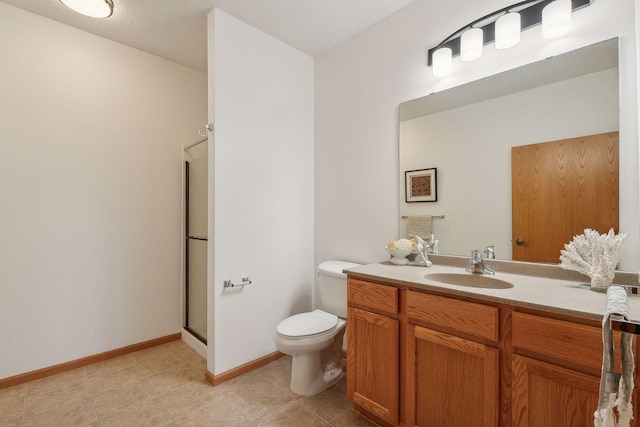 bathroom with vanity, toilet, a shower with door, and a textured ceiling