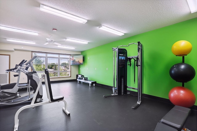 exercise room featuring a textured ceiling and ceiling fan