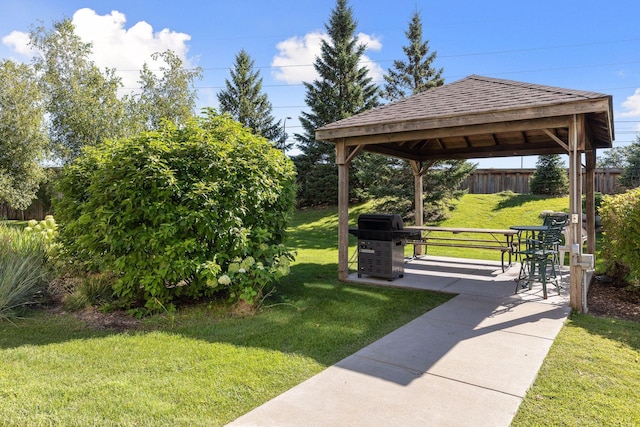 view of property's community featuring a gazebo, a yard, and a patio area