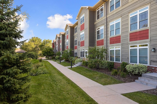 view of home's community with a yard