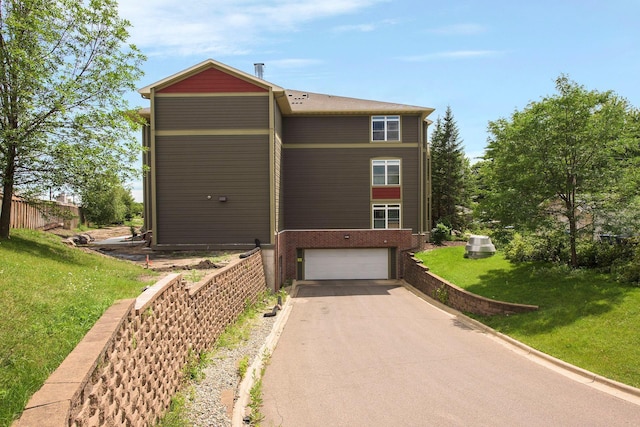 view of front of home featuring a garage and a front lawn