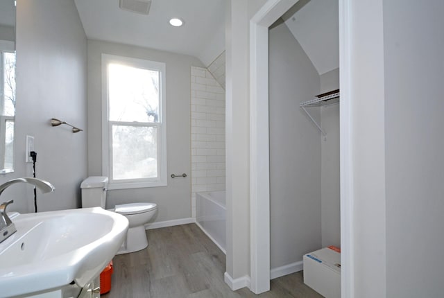 full bathroom featuring sink, wood-type flooring, lofted ceiling, and plenty of natural light