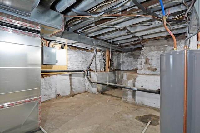 basement featuring water heater and electric panel