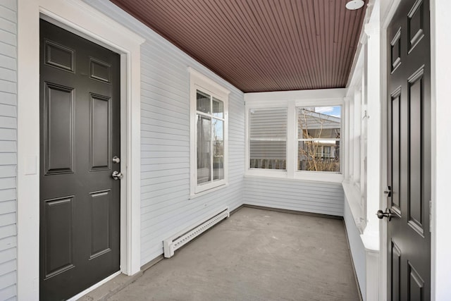 unfurnished sunroom with baseboard heating and wood ceiling