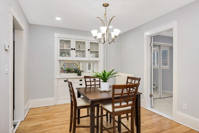 dining room featuring light hardwood / wood-style floors and a notable chandelier