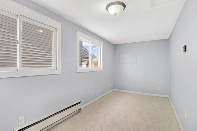 carpeted spare room featuring baseboard heating