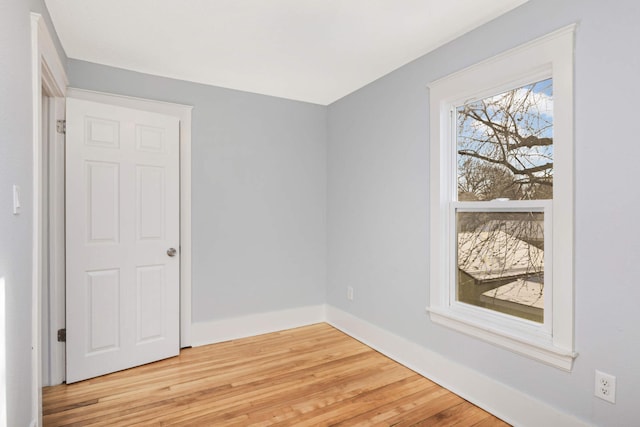 unfurnished room with light wood-type flooring