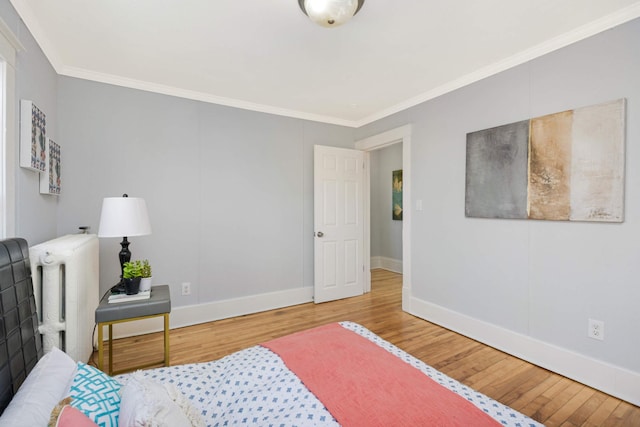 bedroom featuring light hardwood / wood-style flooring and ornamental molding