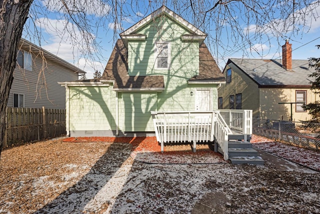 rear view of house featuring a wooden deck