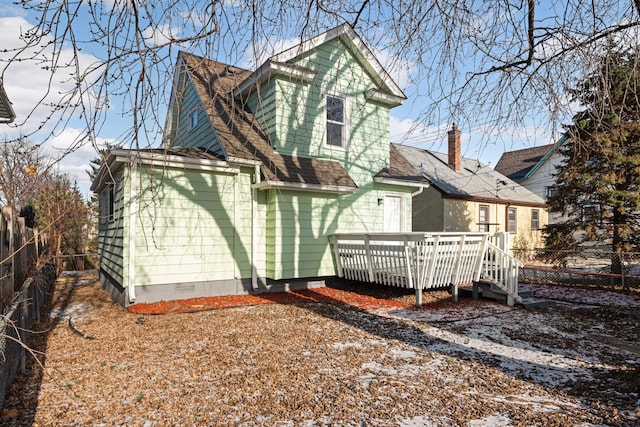 rear view of property featuring a wooden deck