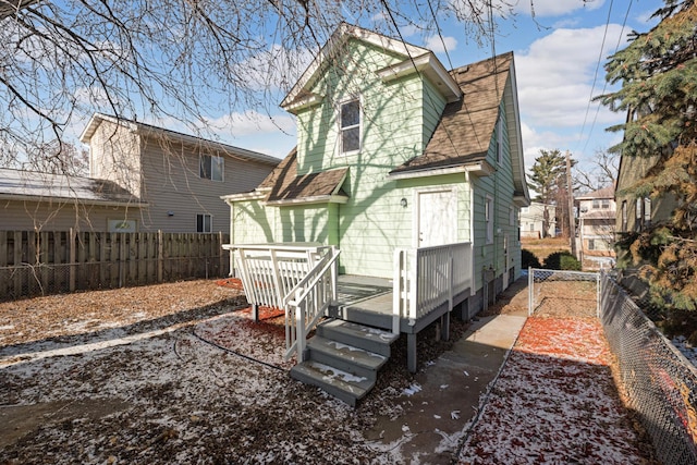 back of house with a wooden deck