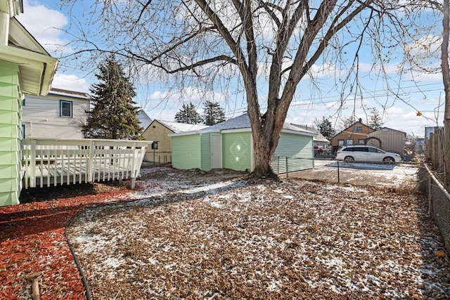 yard layered in snow with an outbuilding