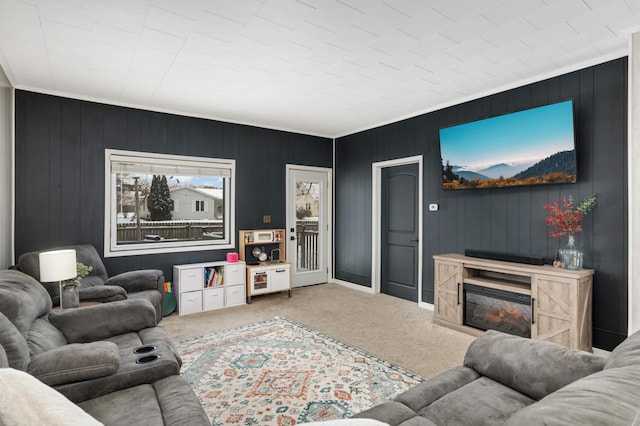 carpeted living room with wood walls