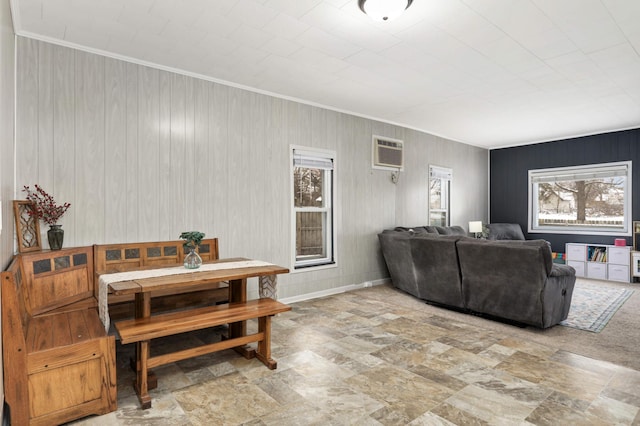 living room featuring wood walls and a wall unit AC