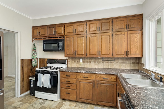 kitchen with sink, dishwashing machine, gas range oven, and ornamental molding