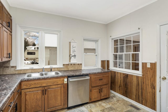 kitchen featuring sink, stainless steel dishwasher, and ornamental molding