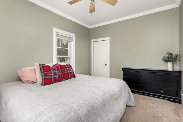 carpeted bedroom with ceiling fan and crown molding