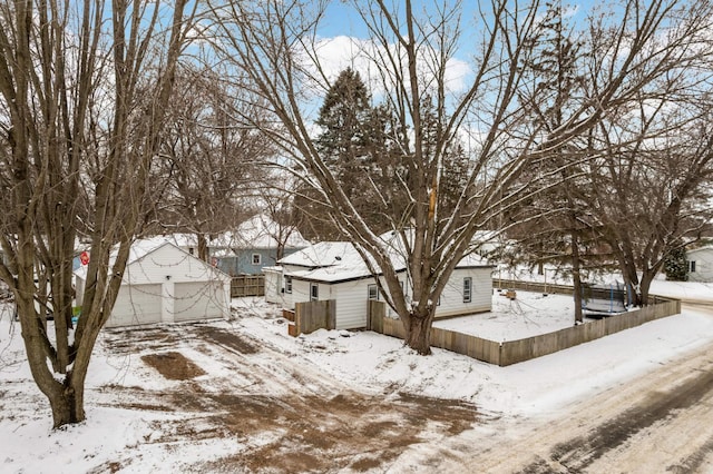 yard layered in snow with a garage