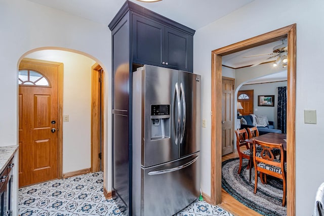 kitchen with ceiling fan and stainless steel refrigerator with ice dispenser